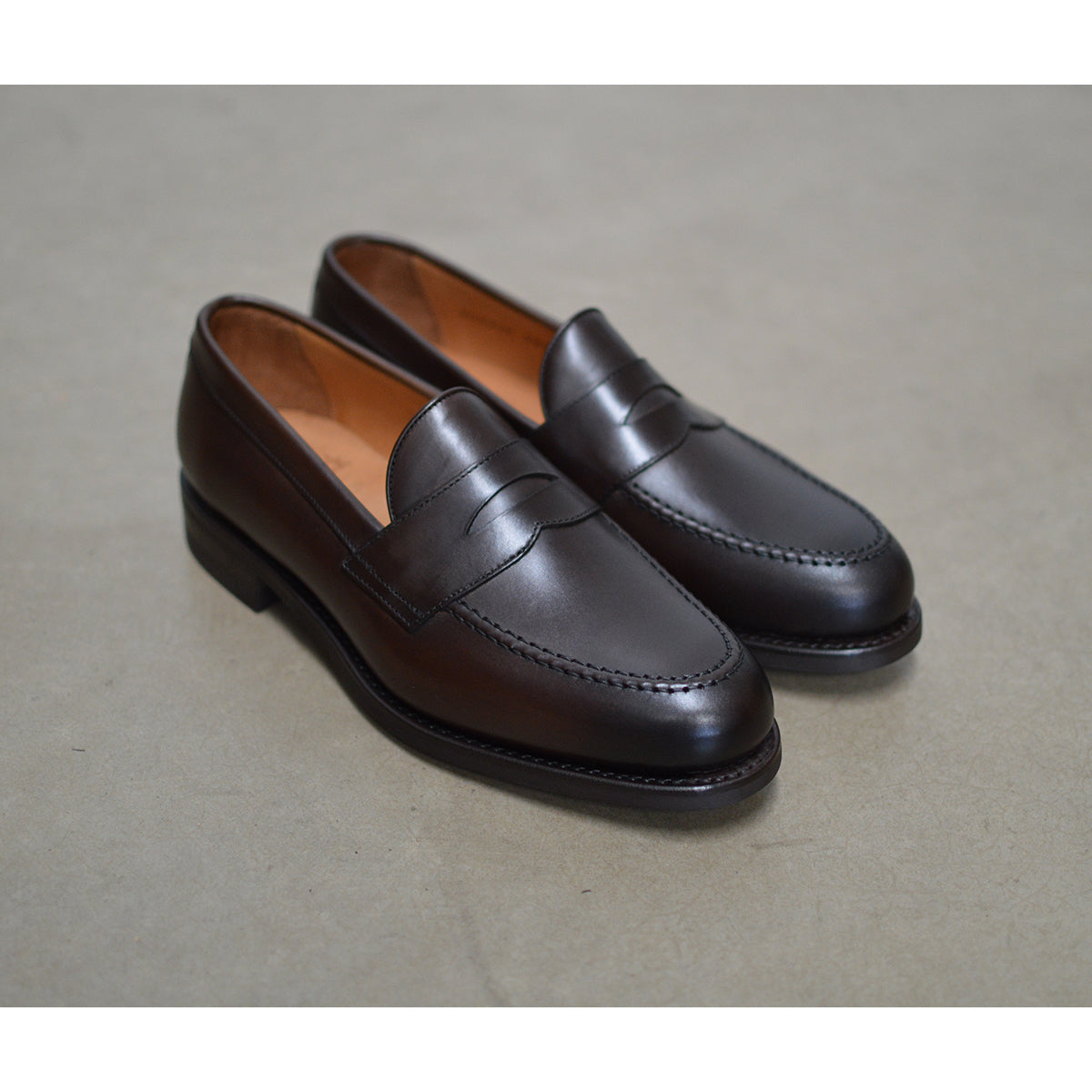 Berwick 1707 Brown leather loafer shoe on a polished concrete background