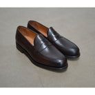 Berwick 1707 Brown leather loafer shoe on a polished concrete background