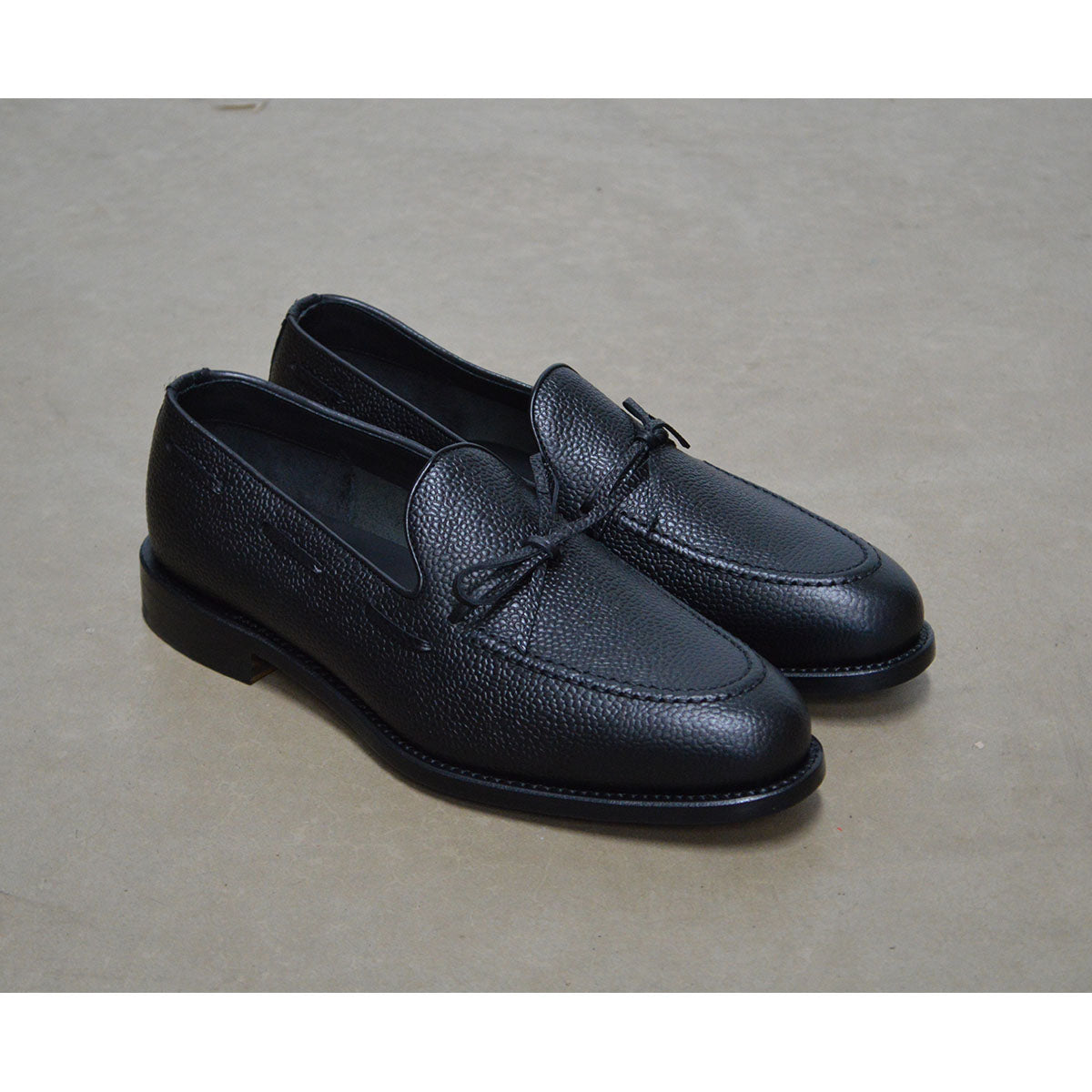 A Berwick 1707 classic black unlined laced slip-on loafer with a Goodyear welted leather sole.