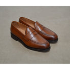 Berwick 1707 Brown tan leather loafer shoe on a polished concrete background with Dainite Soles