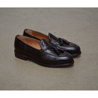 A Berwick 1707 dark brown deerskin slip-on loafer with a tassel detail on the vamp & Dainite sole