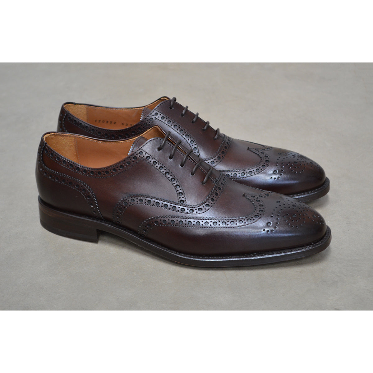 A dark brown Oxford brogue shoe with intricate brogue detailing and a goodyear welted leather sole.