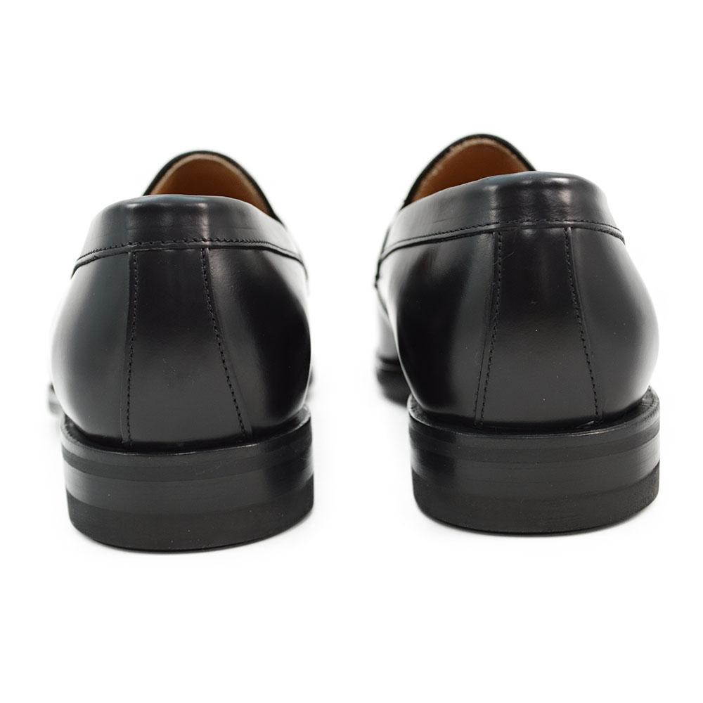 A black high-shine Berwick 1707 Penny Loafer with a round toe and Dainite rubber sole.