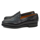 A black high-shine Berwick 1707 Penny Loafer with a round toe and Dainite rubber sole.