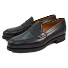 A black high-shine Berwick 1707 Penny Loafer with a round toe and Dainite rubber sole.
