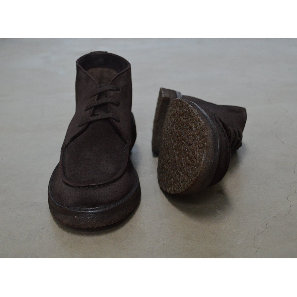 A brown Berwick 1707 apron boot with lace-up closure, handcrafted from reverse kudu suede, featuring moccasin stitching and a crepe rubber sole.