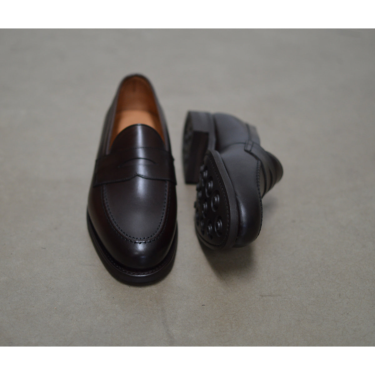 Berwick 1707 Brown leather loafer shoe on a polished concrete background