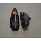 Berwick 1707 Brown leather loafer shoe on a polished concrete background