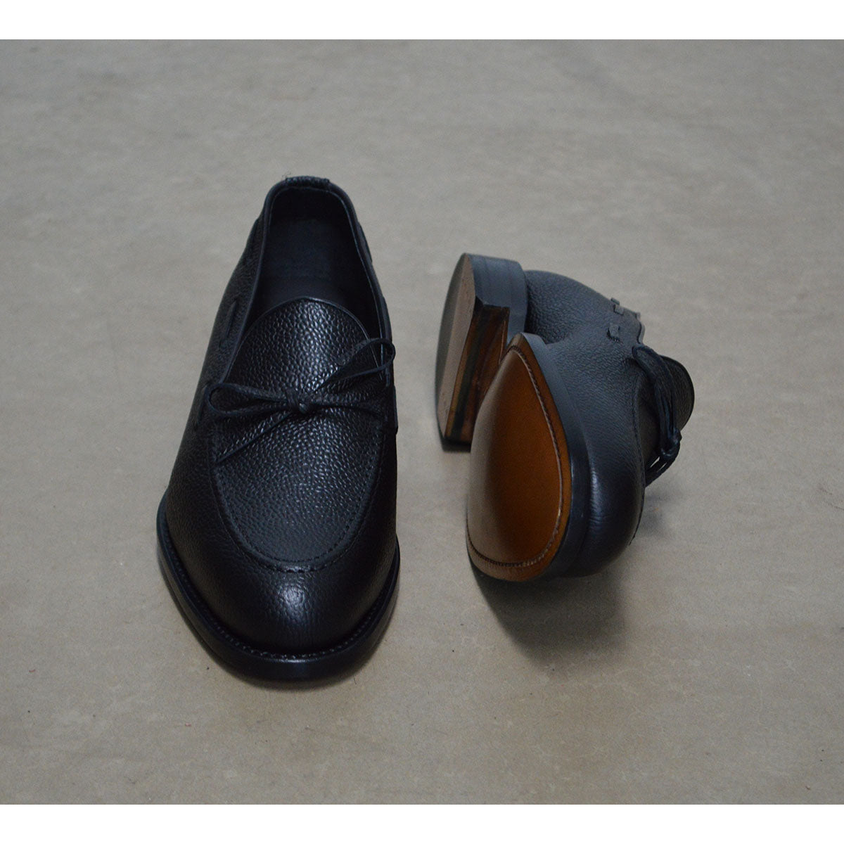 A Berwick 1707 classic black unlined laced slip-on loafer with a Goodyear welted leather sole.
