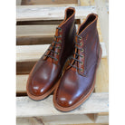 A brown leather service boot with a dainite sole and brass eyelets, designed for the forestry industry.