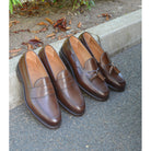 A Berwick 1707 brown tasseled loafer shoe with a closed toe and leather sole.