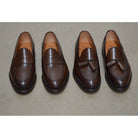 A Berwick 1707 brown tasseled loafer shoe with a closed toe and leather sole.