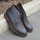 Berwick 1707 Waxy Brown leather chukka boot on a pavement edge background