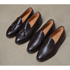 A Berwick 1707 dark brown deerskin slip-on loafer with a tassel detail on the vamp & Dainite sole