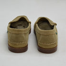 Pair of sand loafers on a white background