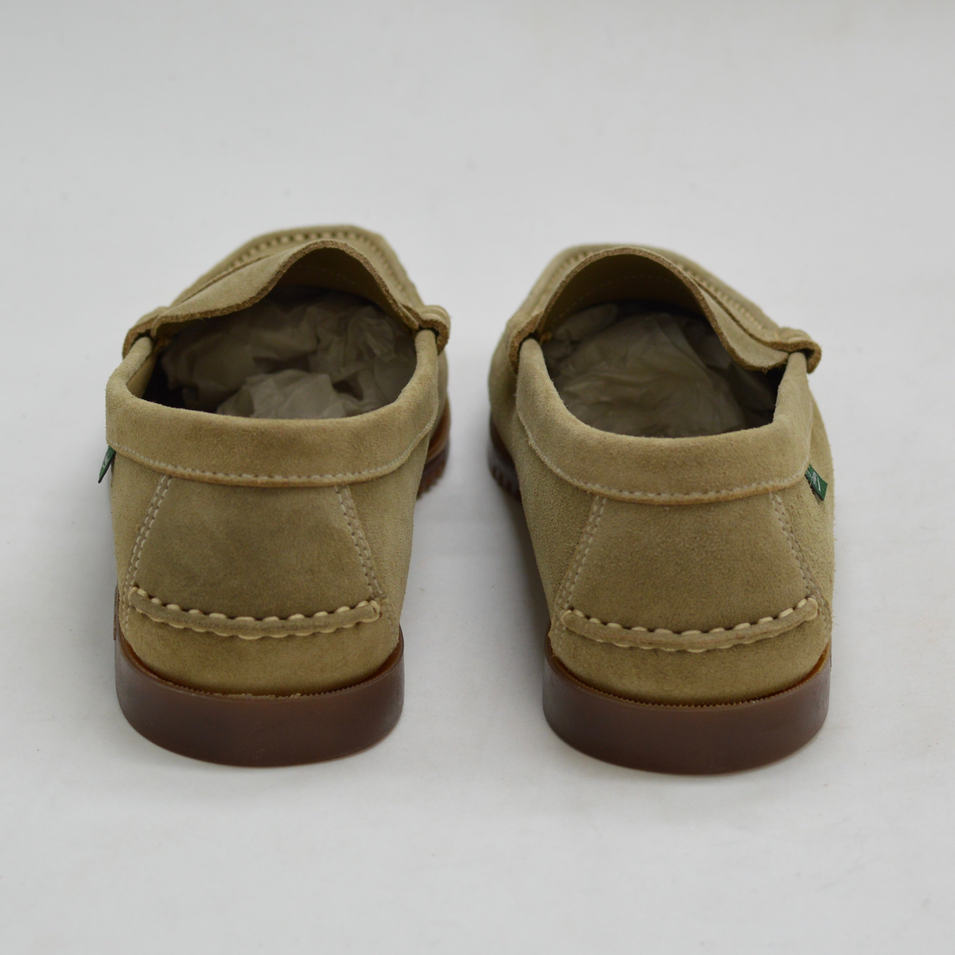 Pair of sand loafers on a white background