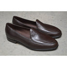 A dark brown deerskin leather Belgian loafer with an almond toe shape and minimal stitching.