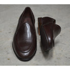 A dark brown deerskin leather Belgian loafer with an almond toe shape and minimal stitching.