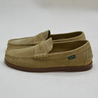 Pair of tan loafers with a brand logo on a light gray background