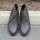 Berwick 1707 Waxy Brown leather chukka boot on a pavement edge background