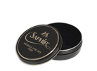 A round tin container of Saphir Medaille D'Or shoe wax polish with black lid and gold lettering.