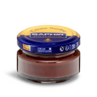 A jar of Saphir Creme Surfine shoe polish with a label on the lid.