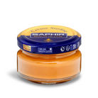 A jar of Saphir Creme Surfine shoe polish with a label on the lid.