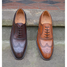 A dark brown Oxford brogue shoe with intricate brogue detailing and a goodyear welted leather sole.