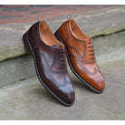 A dark brown Oxford brogue shoe with intricate brogue detailing and a goodyear welted leather sole.