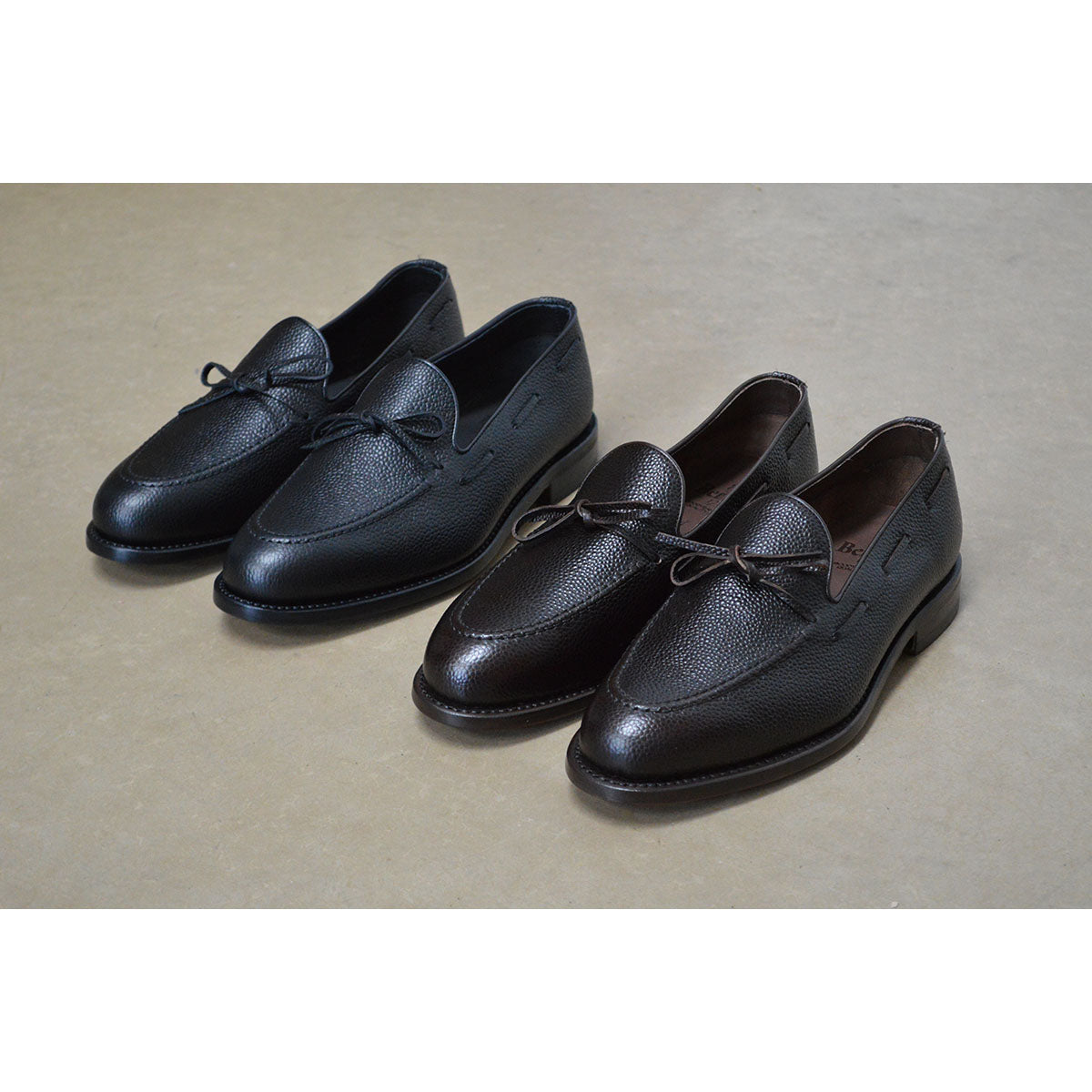 A Berwick 1707 classic black unlined laced slip-on loafer with a Goodyear welted leather sole.