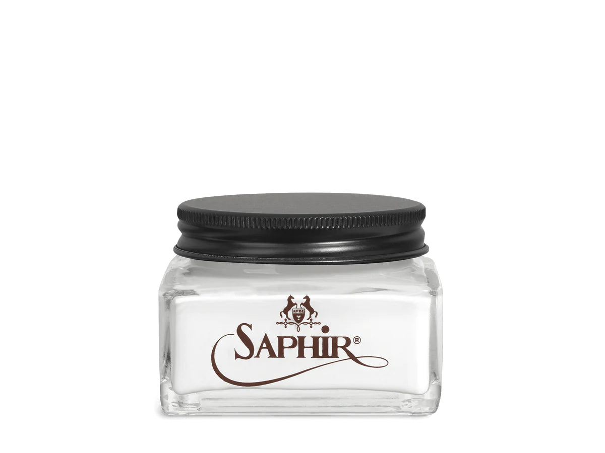 A glass jar with a black lid labeled 'SAPHIR' containing cream shoe polish.