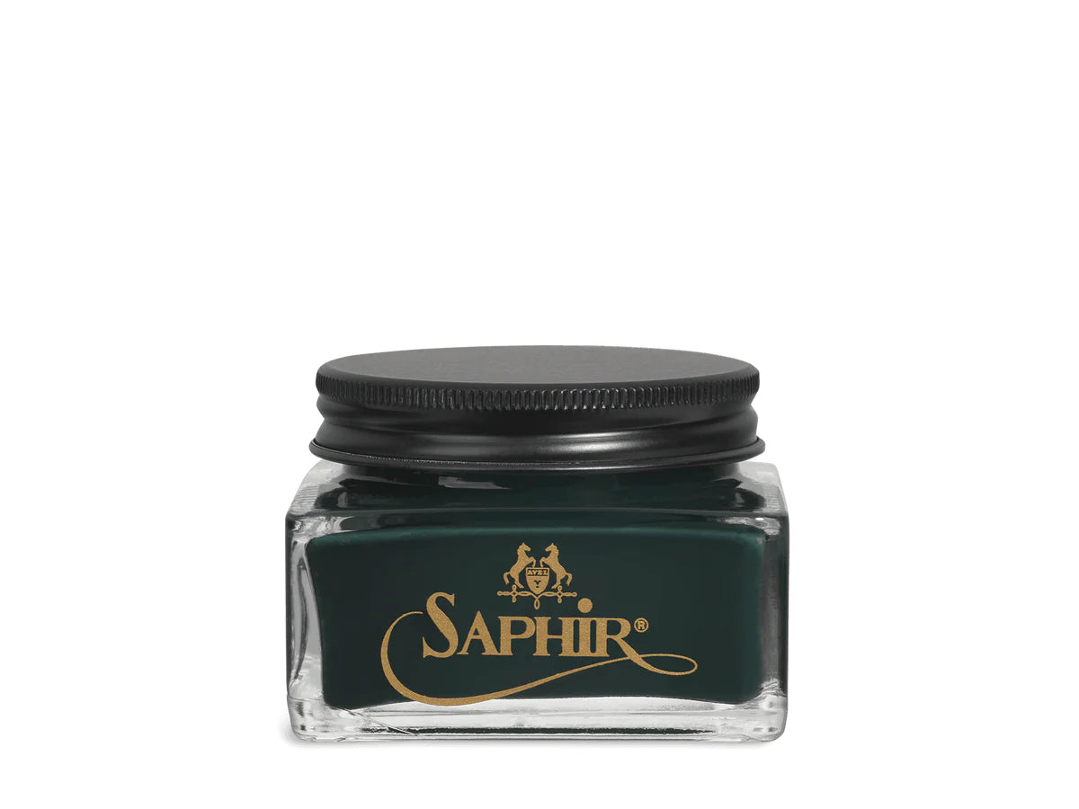 A glass jar with a black lid labeled 'SAPHIR' containing cream shoe polish.