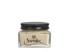 A glass jar with a black lid labeled 'SAPHIR' containing cream shoe polish.
