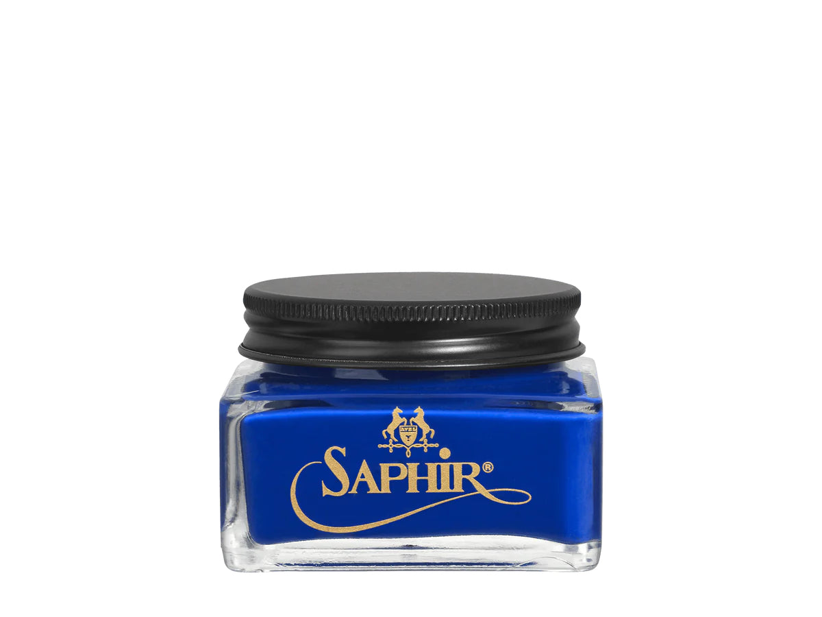 A glass jar with a black lid labeled 'SAPHIR' containing cream shoe polish.