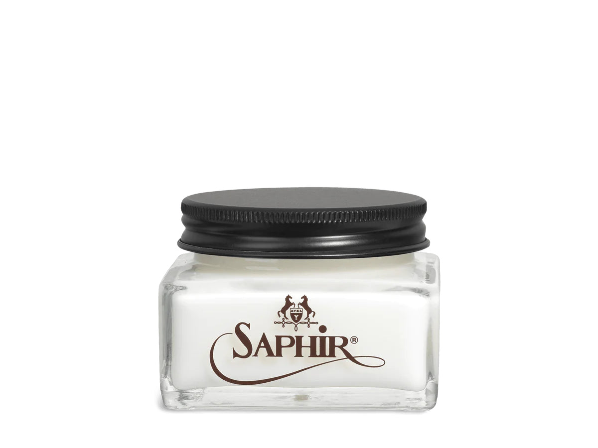 A glass jar with a black lid labeled 'SAPHIR' containing cream shoe polish.