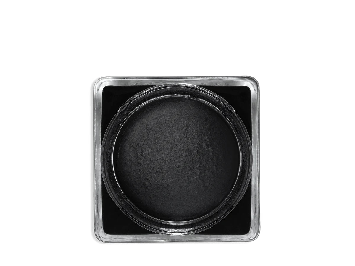 A glass jar with a black lid labeled 'SAPHIR' containing cream shoe polish.
