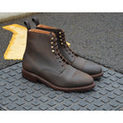 A Berwick 1707 dark brown, waxed roughout suede classic country toe cap derby boot with Dainite rubber sole and lace-up closure.