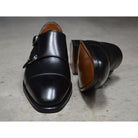A Berwick 1707 lack double monk shoe with two buckle straps, made from calf leather and featuring a Goodyear welted leather sole.