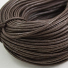 brown coloured waxed round casual shoe laces, tied in individual bundles.