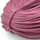 pink coloured waxed round casual shoe laces, tied in individual bundles.