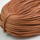 tan coloured waxed round casual shoe laces, tied in individual bundles.