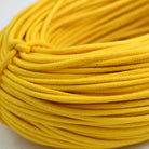 yellow coloured waxed round casual shoe laces, tied in individual bundles.