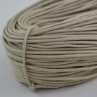 beige coloured waxed round casual shoe laces, tied in individual bundles.