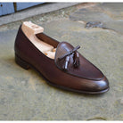 A Berwick 1 707 dark brown leather Belgian loafer with a braided leather bow tie and tassel adornment.