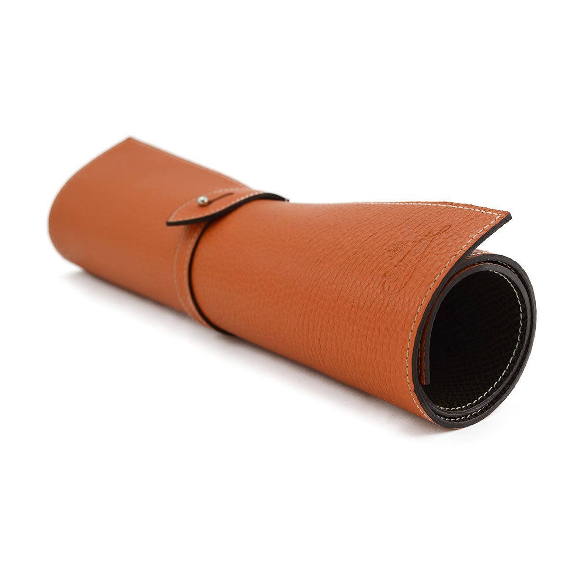 A Saphir Medaille D'Or rolled-up orange leather shoeshine mat with a nickel stud on the exterior.