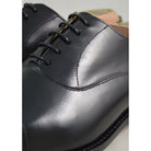 Elegant black chisel toe oxford shoe made of box calf leather with a goodyear welted single leather sole.