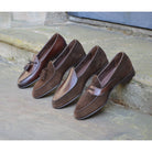 A Berwick 1 707 dark brown leather Belgian loafer with a braided leather bow tie and tassel adornment.