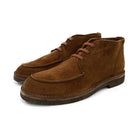 A brown Berwick 1707 5432 Apron Boot with lace-up closure, handcrafted from reverse kudu suede, featuring moccasin stitching and a crepe rubber sole.