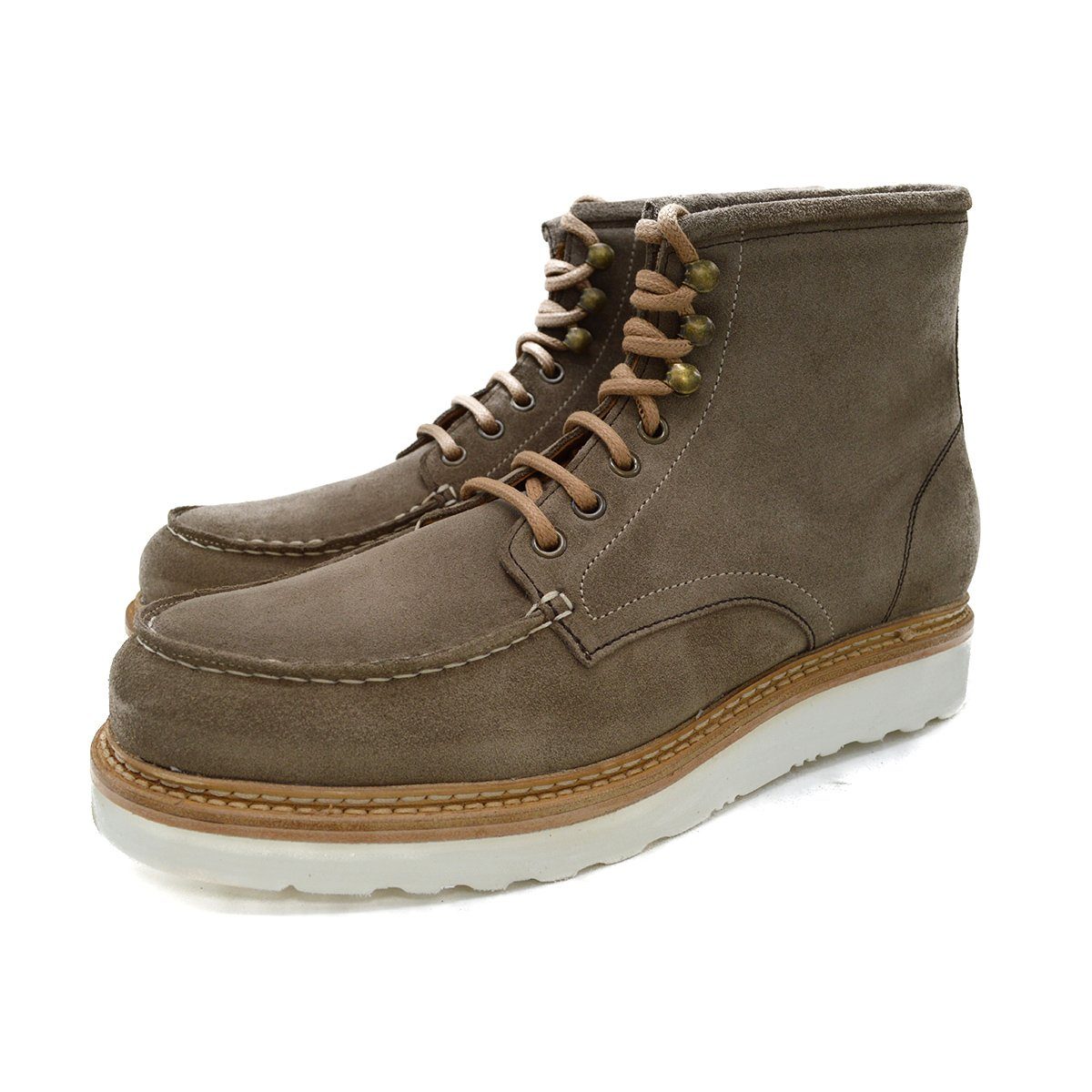 A grey and tan suede apron boot with lace-up closure, featuring a white sole and a natural welt.