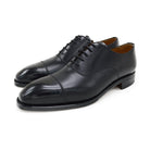 A black, boxcalf leather Oxford shoe with a chisel toe and lace-up closure, crafted in Spain.